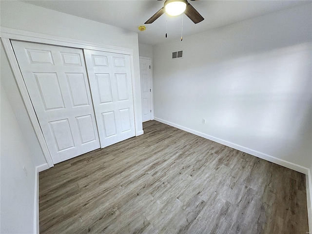 unfurnished bedroom with ceiling fan, light hardwood / wood-style flooring, and a closet