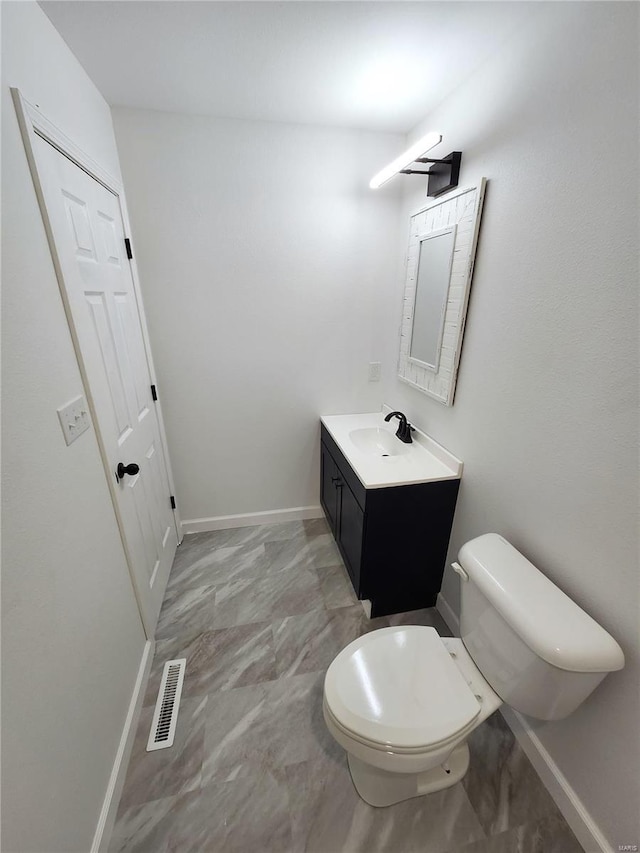 bathroom featuring toilet and vanity