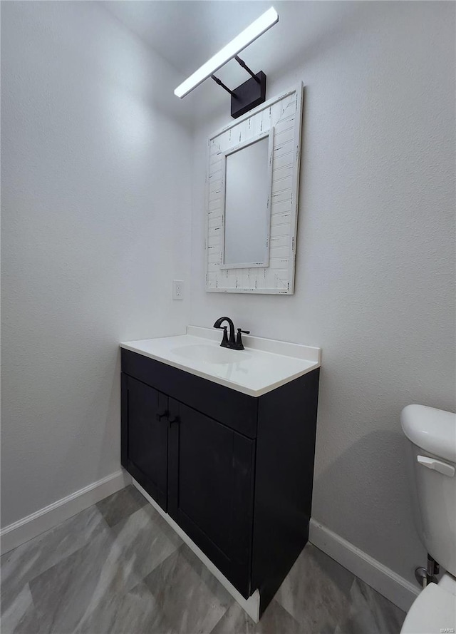 bathroom with toilet and vanity