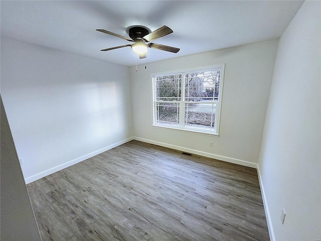 empty room featuring ceiling fan and hardwood / wood-style flooring