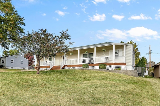 manufactured / mobile home featuring covered porch and a front lawn