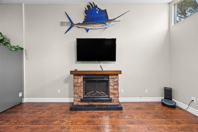 unfurnished living room featuring dark hardwood / wood-style floors and a fireplace