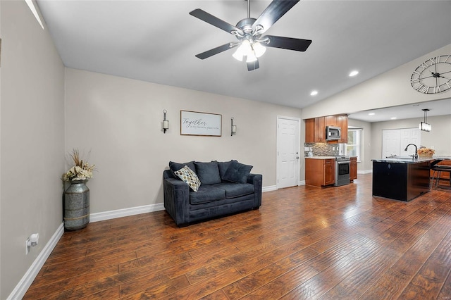 living room with ceiling fan, dark wood-type flooring, sink, and lofted ceiling