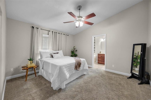 carpeted bedroom featuring ceiling fan, lofted ceiling, and ensuite bath