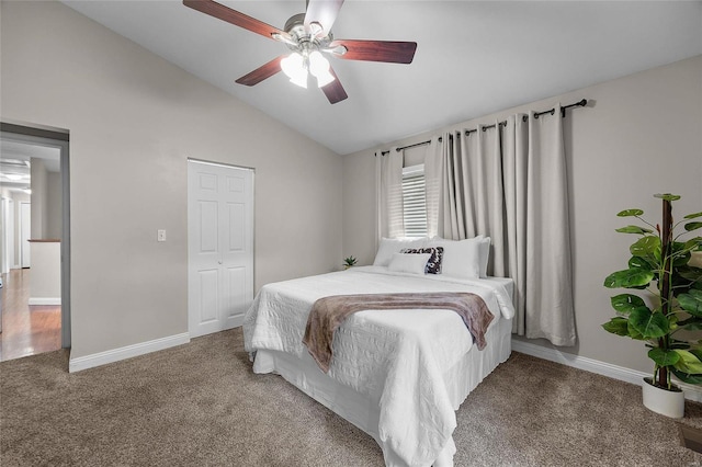 carpeted bedroom with ceiling fan, a closet, and lofted ceiling