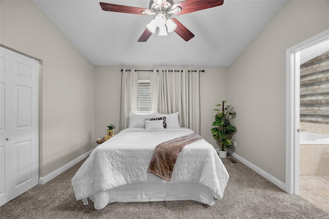 bedroom featuring ceiling fan, ensuite bathroom, and carpet floors