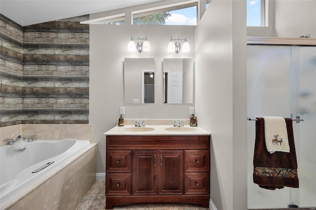 bathroom with vanity, separate shower and tub, and vaulted ceiling