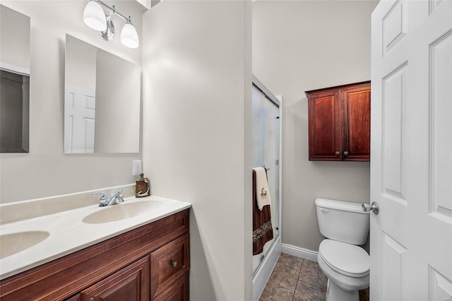 bathroom featuring toilet, vanity, and walk in shower