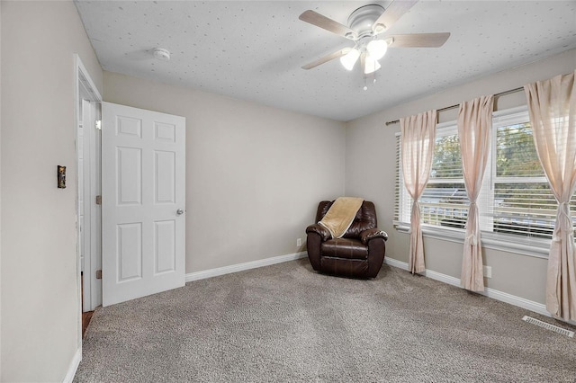 unfurnished room featuring ceiling fan and carpet floors