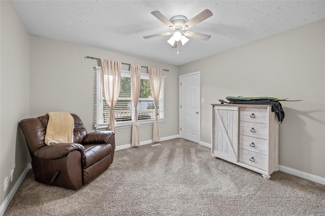 living area with ceiling fan and carpet floors