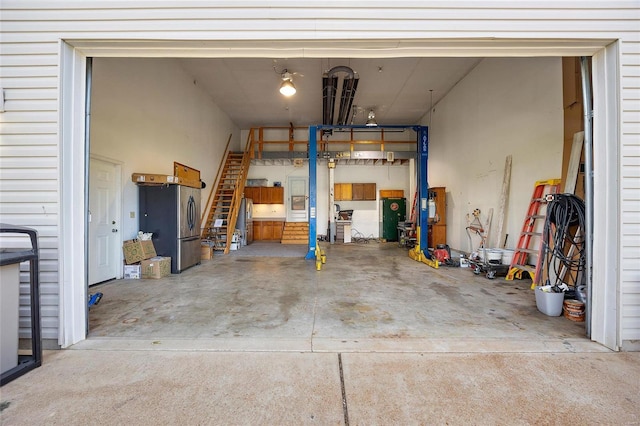 garage with stainless steel refrigerator