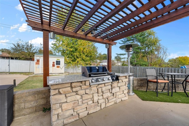 view of patio featuring exterior kitchen, a grill, a storage shed, and a pergola