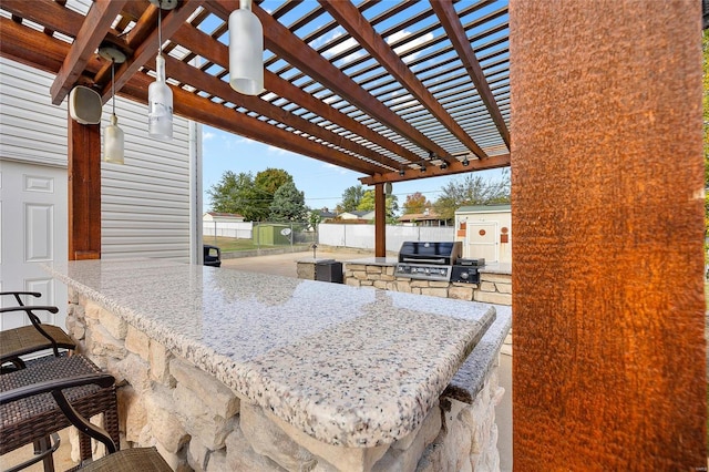 view of patio / terrace with grilling area, a pergola, an outdoor kitchen, and a bar