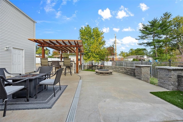 view of patio with an outdoor fire pit, an outdoor bar, and a pergola