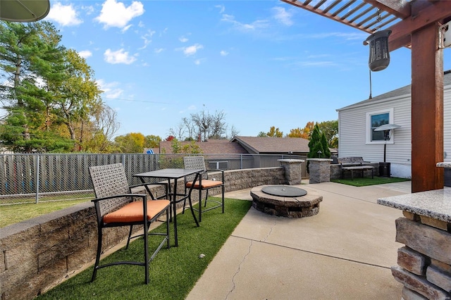 view of patio / terrace with a pergola and a fire pit