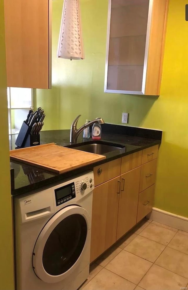 washroom featuring cabinets, washer / clothes dryer, sink, and light tile patterned floors