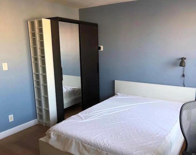 bedroom featuring dark hardwood / wood-style flooring