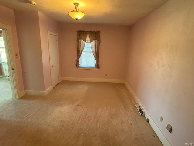 unfurnished room with light carpet