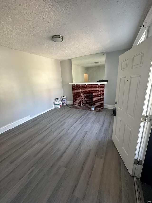 interior space with hardwood / wood-style floors, a fireplace, and a textured ceiling