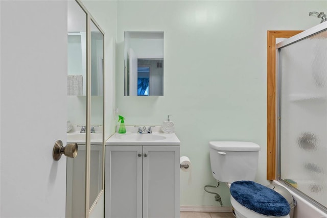 full bathroom with vanity, toilet, and combined bath / shower with glass door