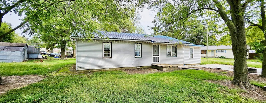 rear view of house with a patio area and a yard