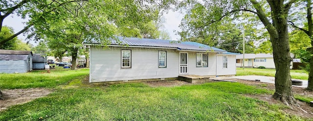 rear view of house with a patio area and a yard