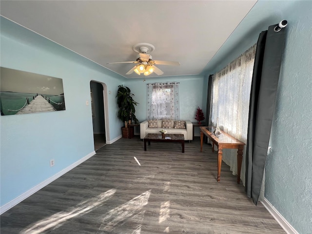 sitting room with ceiling fan and dark hardwood / wood-style flooring