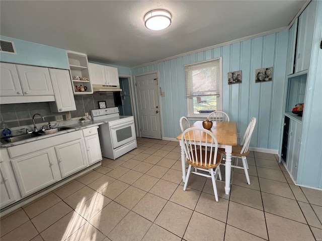 kitchen with white cabinetry, light tile patterned flooring, backsplash, and white range with electric cooktop