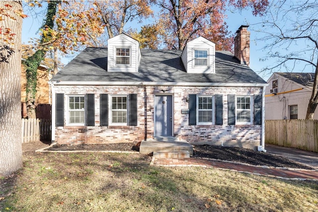 new england style home featuring a front yard