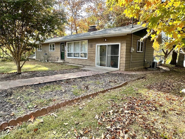 rear view of property with central air condition unit and a patio area