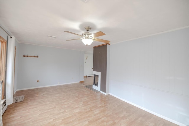 unfurnished living room featuring ceiling fan, light hardwood / wood-style floors, and ornamental molding