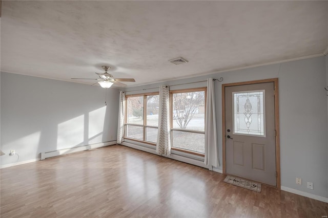 foyer featuring ceiling fan, crown molding, light hardwood / wood-style flooring, and a baseboard heating unit