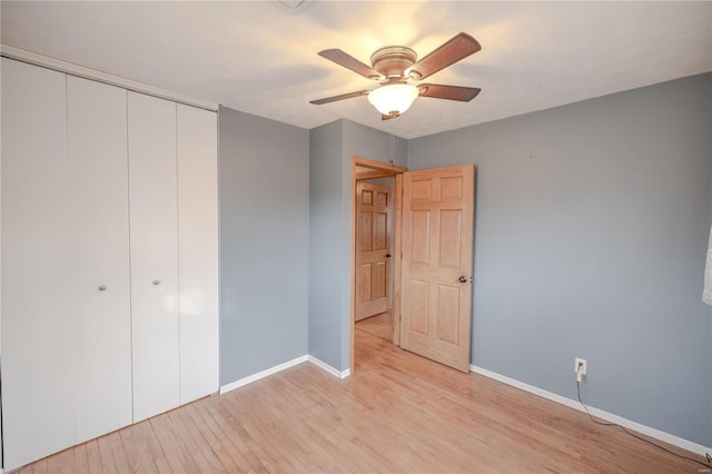 unfurnished bedroom with light wood-type flooring, a closet, and ceiling fan