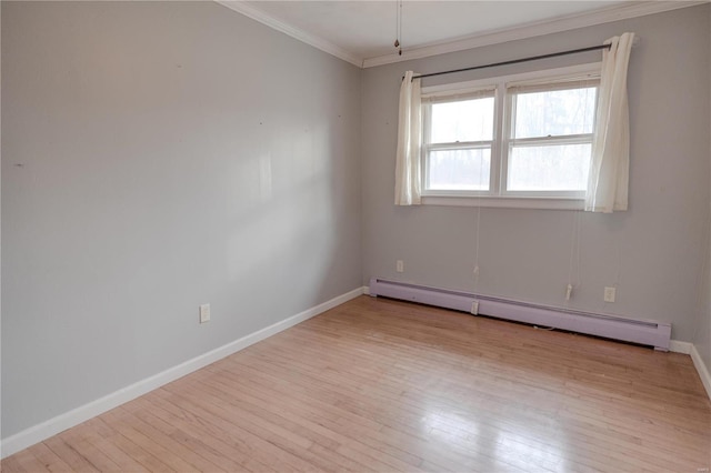 empty room with light hardwood / wood-style floors, crown molding, and a baseboard heating unit