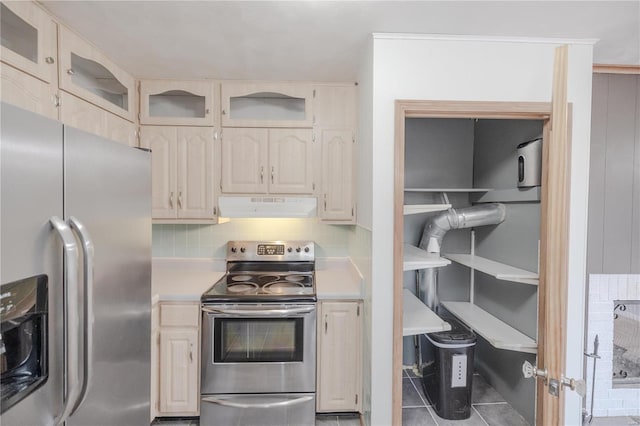 kitchen with backsplash, tile patterned flooring, and appliances with stainless steel finishes