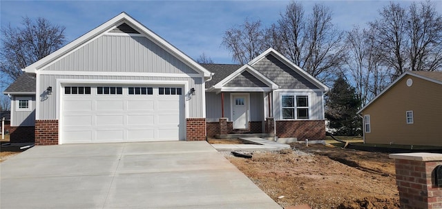 view of front of property with a garage, concrete driveway, brick siding, and board and batten siding