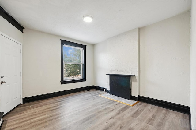 spare room featuring wood-type flooring