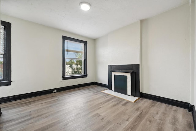 unfurnished living room with light hardwood / wood-style flooring