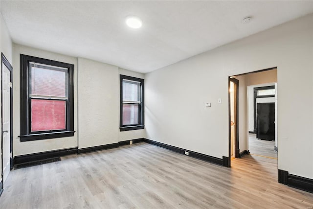 empty room with light hardwood / wood-style floors