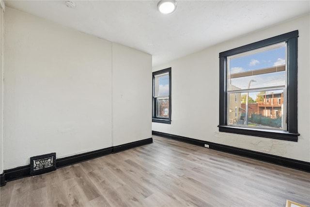 spare room featuring light hardwood / wood-style flooring