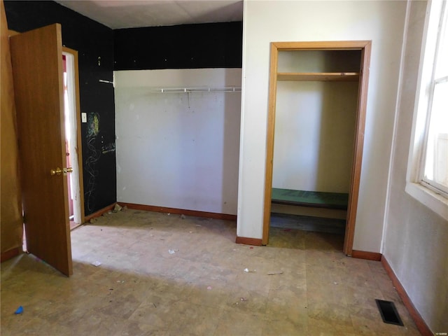 unfurnished bedroom with two closets