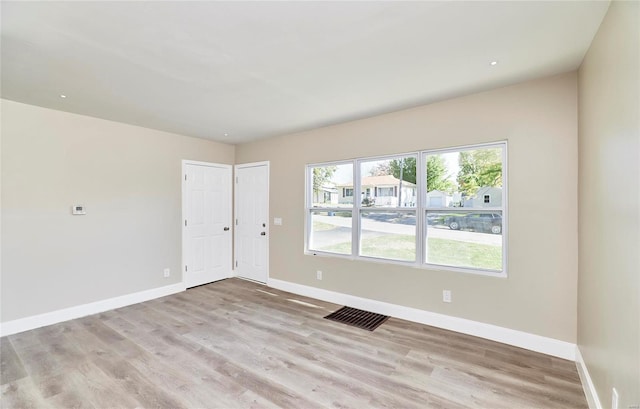 unfurnished room featuring light wood-type flooring