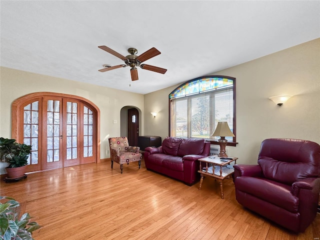 living room featuring light wood-type flooring and ceiling fan