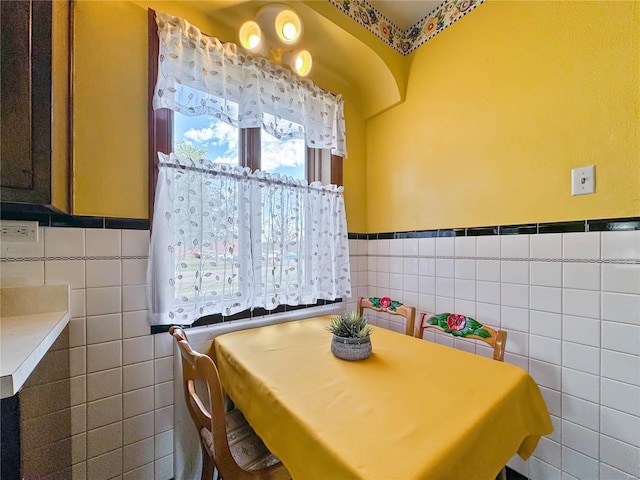 dining area with tile walls