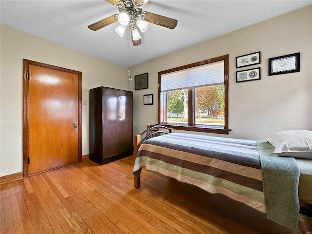 bedroom featuring light wood-type flooring and ceiling fan