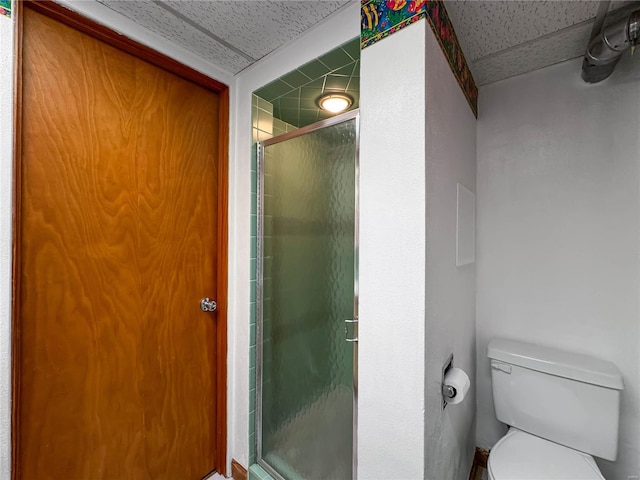 bathroom featuring toilet and an enclosed shower