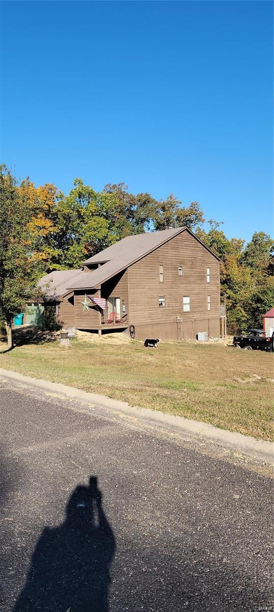 view of property exterior featuring a lawn