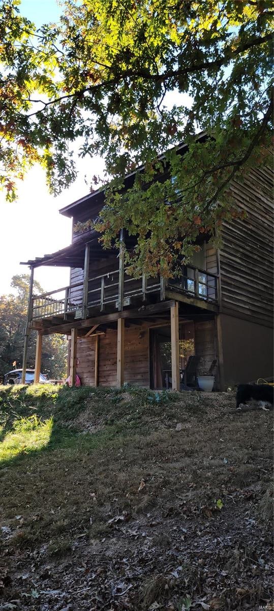 view of property exterior featuring a wooden deck