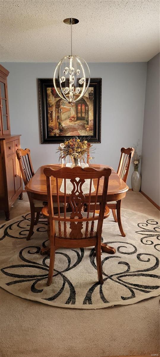 carpeted dining area featuring an inviting chandelier and a textured ceiling