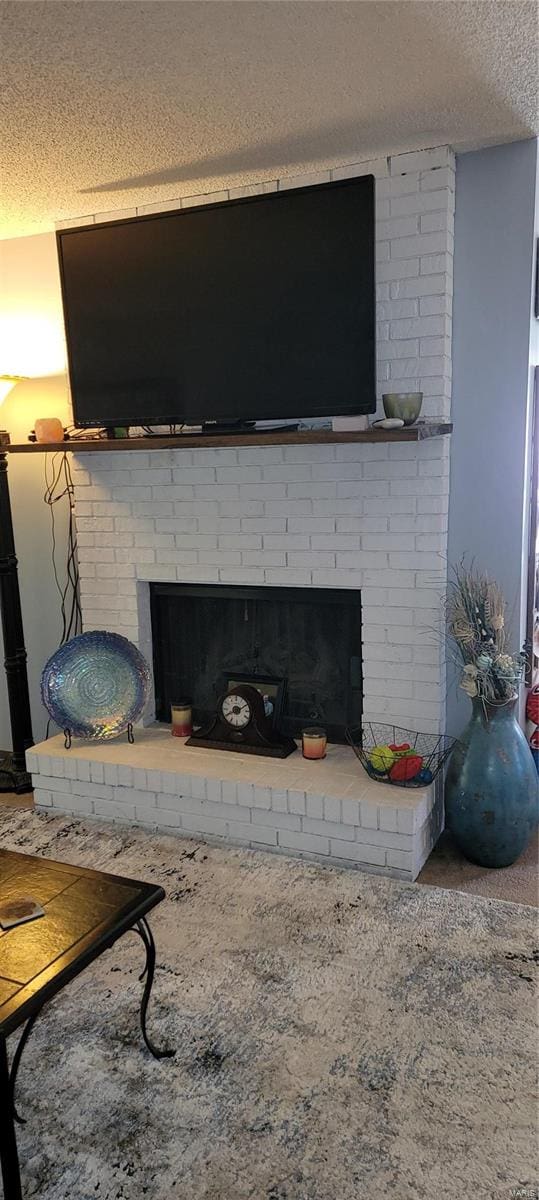 room details featuring a textured ceiling, carpet floors, and a fireplace